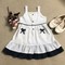 Đầm bé gái xòe 2 dây trắng chấm bi đen có túi đính nơ D02 TRANG